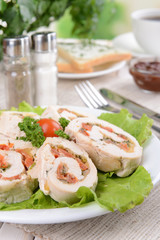 Delicious chicken roll on plate on table close-up