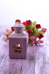 Decorative metallic lantern and artificial flowers