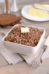 Boiled buckwheat in bowl on table close-up
