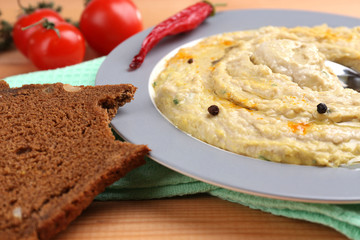 Bowl of tasty fresh hummus with tomatoes