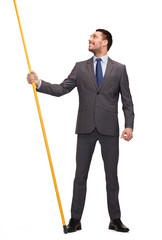 smiling man holding flagpole with imaginary flag