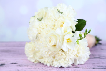 Beautiful wedding bouquet on table on bright background