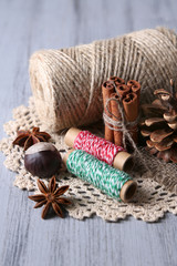 Composition with natural bump, thread, cinnamon sticks
