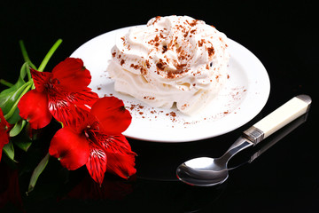 Tasty cake with cream, on black background © Africa Studio