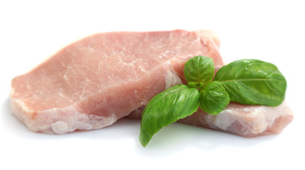 Raw meat steaks with basil isolated on white