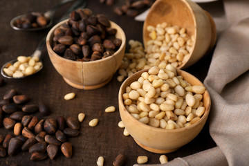 Cedar pine nuts in bowls, on wooden table