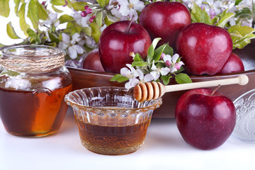 .apples in a bowl with honey and apple flower