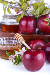 .apples in a bowl with honey and apple flower