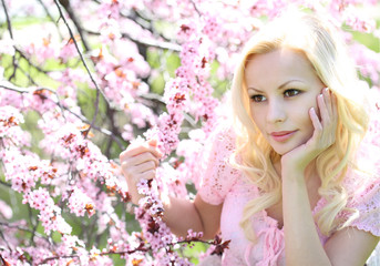 Obraz na płótnie Canvas Blonde Girl with Cherry Blossom. Spring Portrait. Beautiful