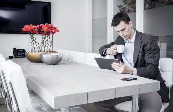 Man using tablet pc at the office in meeting room
