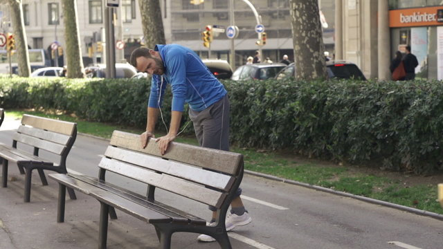 Female joggers running, man resting in the city