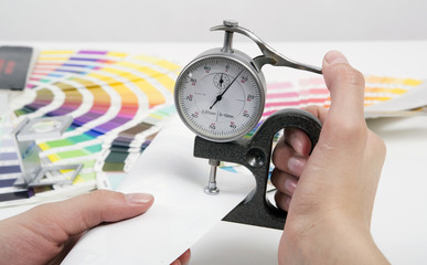 Measurement of thickness of a material by a micrometer
