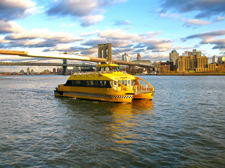 Water Taxi and Brooklyn bridge, seen from Pier 17, at Lower Manh