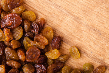 Diet healthy food. Border of raisin on wooden background