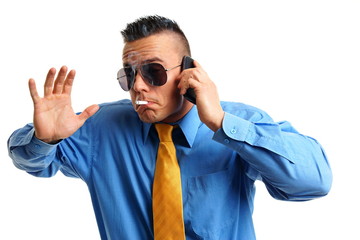 Fototapeta premium Crazy businessman smokes a cigarette and talks into mobile phone