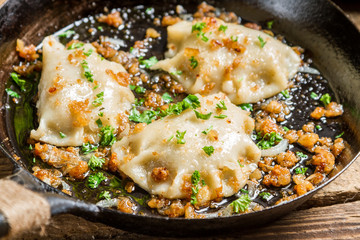 Homemade dumplings fried with onion and parsley
