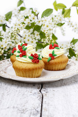 Beautiful rose cupcake and bird cherries in the background