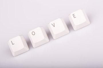 text love formed with computer keyboard keys on white background