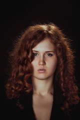 portrait of a glamorous young woman on dark background