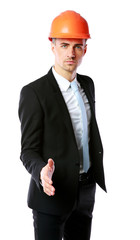 Confident businessman in helmet offering handshake