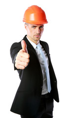 Businessman in helmet giving thumbs up over white background