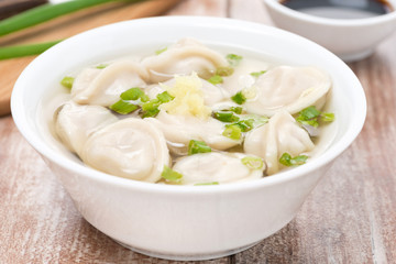 Chinese dumplings in chicken broth, close-up