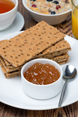 delicious breakfast - crisp bread with orange jam, close-up