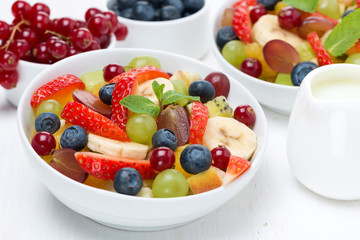 fruit and berry salad and jug of cream