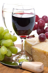 grapes, cheese and two glasses of wine, close-up