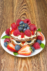 Pancake cake with whipped cream and fresh berries