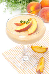 peach souffle in glass and fruit in the background, close-up