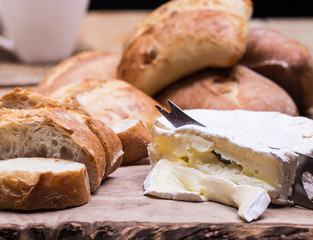 blue cheese and  bread rools on the table