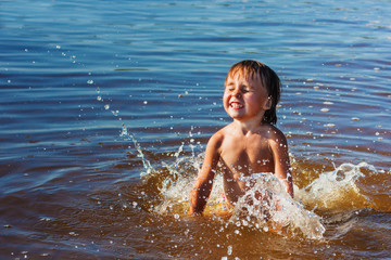 girl swims and playing on the sea