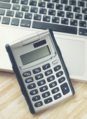 Calculator and a makbook on the background