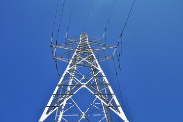 High power  tower pole against blue sky