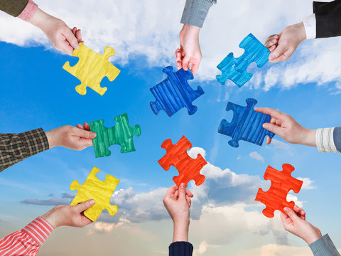 People Hands With Puzzle Pieces With Afternoon Sky