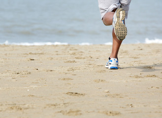 Rear view of man jogging at the beach