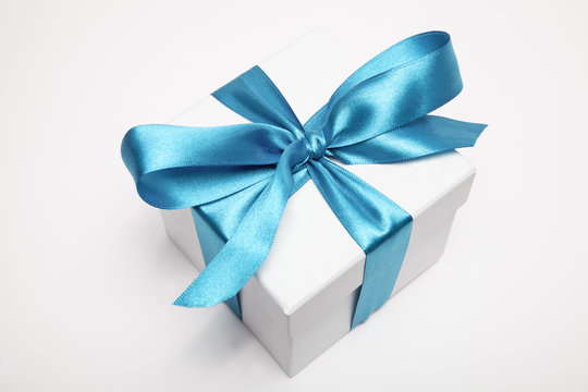 Open gift box with blue ribbon Stock Photo by ©Sashkin7 90048396