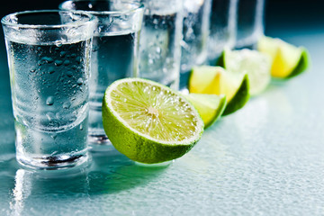 tequila and lime on glass table