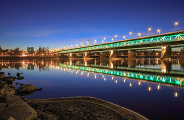 Illuminated bridge at night