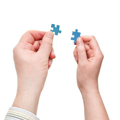 male and female hands with little puzzle pieces
