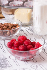 raspberries hazelnuts and butter in glass bowls