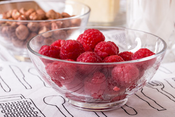raspberries hazelnuts and butter in glass bowls