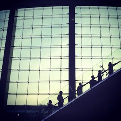 silhouettes man going up by escalator
