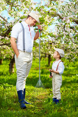 family working together in spring apple garden