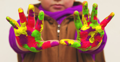 Child with colorful hands