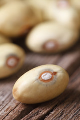 Raw yellow kidney beans on an old wooden macro