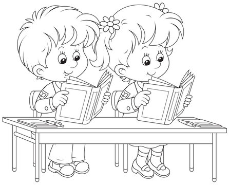 Schoolchildren read at their desk in a class