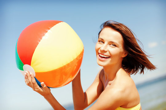 Girl In Bikini Playing Ball On The Beach