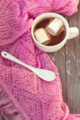 cup of hot chocolate wrapped in a scarf
